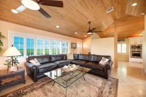 a living room with a leather couch and a table at Relaxing 2 2 Get Away in the Lower Keys! home in Summerland Key