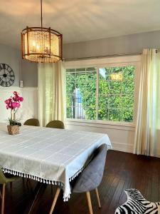 a dining room with a table and a window at Hollywood house with parking - walk to attractions in Los Angeles