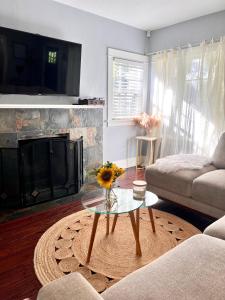 a living room with a fireplace and a coffee table at Hollywood house with parking - walk to attractions in Los Angeles