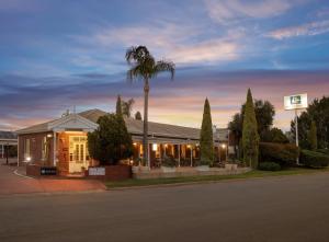 a building with a palm tree in front of it at Breakfree Port Pirie in Port Pirie