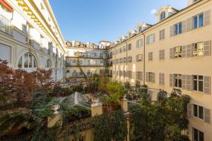 an apartment building with plants on the balconies at Splendido appartamento in Piazza San Carlo in Turin