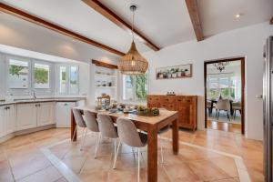 a kitchen with a wooden table and chairs at VACATION MARBELLA I Villa Ballesteros, Near Golf Courses, Private Pool and Gigantic Garden in Estepona