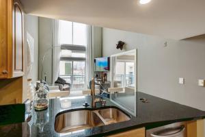 a kitchen with a sink and a mirror at Modern Downtown Top Floor Penthouse With Bay Views in Seattle