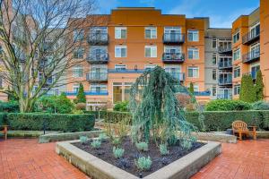 a garden in front of a building at Modern Downtown Top Floor Penthouse With Bay Views in Seattle