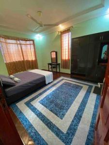 a bedroom with a bed and a large rug at Indah Jaya Homestay in Sandakan
