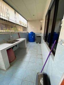 an empty bathroom with a sink and a mirror at Indah Jaya Homestay in Sandakan