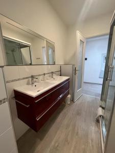a bathroom with two sinks and a large mirror at Cinque terre Portovenere in La Spezia