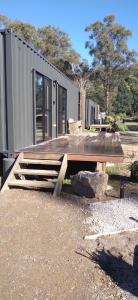 a wooden picnic table in front of a tiny house at Rail Trail Retreat in Scottsdale