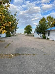 an empty road in front of a house at Bluebird Motel in Claresholm