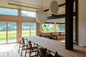 a large dining room with a long table and chairs at 奥阿賀七名庵　らくら in Aga