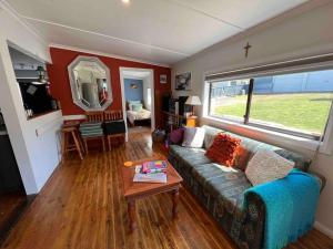 a living room with a couch and a table at Chillin at Adaminaby FSC home in Adaminaby in Adaminaby