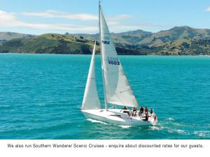 a group of people on a sail boat in the water at Akaroa Coastal Studio in Akaroa
