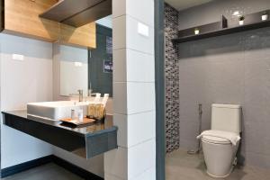 a bathroom with a sink and a toilet at Raweewan Residence hotel in Bangkok