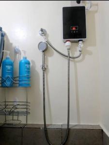 a hose hooked up to a wall with aperature at Cozy Condo in Davao City
