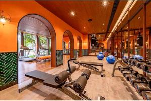 a gym with a bunch of exercise equipment in it at Lahabana Resort in Hua Hin