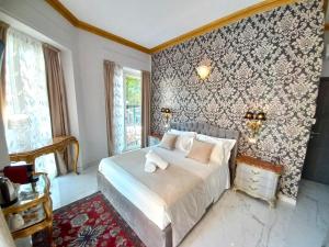 トリノにあるDorotea Rooms Torino Centroの壁紙のベッドルーム1室(ベッド1台付)