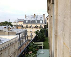 a view of a city from a balcony at Le Ciel de Paris - Montparnasse & Jardin du Luxembourg in Paris