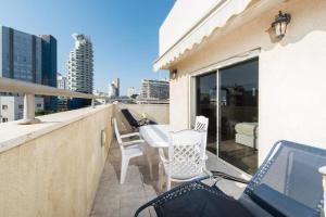 A balcony or terrace at Spacious Duplex with Terrace & Mamad 3-min From the Beach by Sea N' Rent
