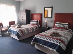 Postel nebo postele na pokoji v ubytování Obesa Lodge