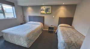 Postel nebo postele na pokoji v ubytování Phoenix Palm Motel