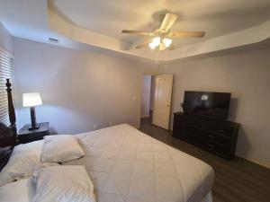 a bedroom with a bed and a ceiling fan at Heart of Branson #1 in Branson