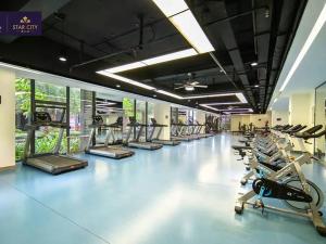 a gym with a row of treadms and machines at Star City 星汇城 in Phnom Penh