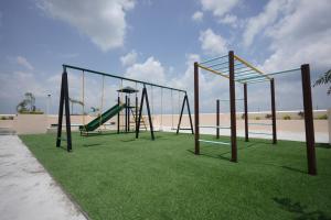 an empty playground with a swing set on the grass at Erwanos Crib 2 Bedroom Condo with Balcony in Naga