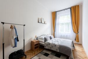 a bedroom with a bed and a window at Prague - Karlin Apartments in Prague