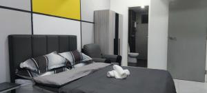 a bedroom with a large bed and a bathroom at Meritus Service Apartment in Perai