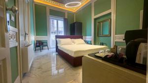 a bedroom with a bed in a room with green walls at Palazzo Maqueda in Palermo