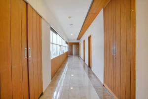 an empty hallway with wooden cabinets and a long corridor at FabHotel Prime Blue Moon in Gandhinagar