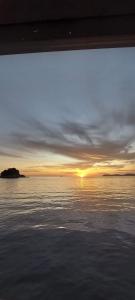 a view of the sunset from a boat in the water at Ella's Place Salang Tioman in Tioman Island