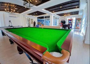 a pool table in the middle of a room at Seven Seas 2 mr.Karl in Na Jomtien