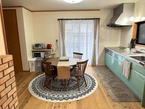 a kitchen with a table and chairs in a room at HEARTH_YOSHINO in Yoshino