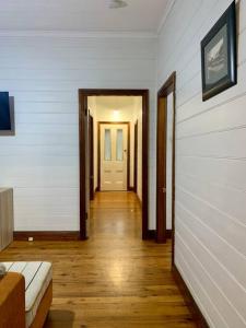 a hallway leading to a room with a door at Quarryman Cottage @ 102 in Bowral