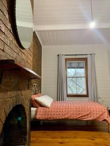 a bedroom with a bed in a room with a window at Quarryman Cottage @ 102 in Bowral