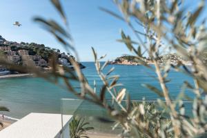 a view of a beach and the ocean at Hotel Marina in Port de Soller