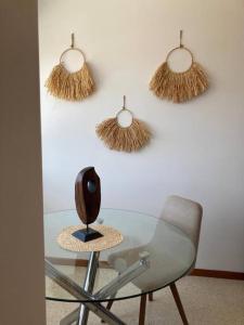 a glass desk with a chair and a table with a lamp at Apartamento Illa de Tambo in Marín