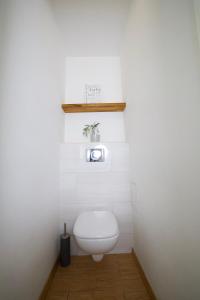 a bathroom with a white toilet in a room at Warsaw Apartament Ochota in Warsaw