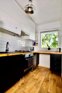 a kitchen with a counter top and a window at Warsaw Apartament Ochota in Warsaw