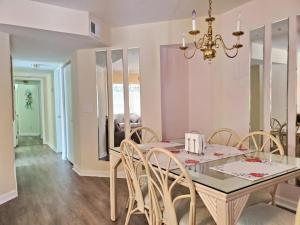 a dining room with a table with chairs and a chandelier at 3B2FB Blissful Surfside Life a peaceful quiet getaway 25 years old and Up ONLY in Myrtle Beach