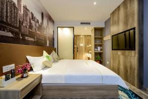 a bedroom with a large bed and a television at Heye International Youth Hostel in Chongqing