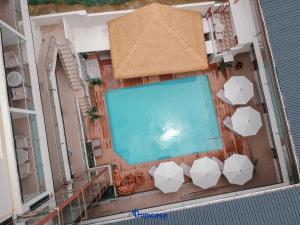 an overhead view of a swimming pool with umbrellas at Tropicasa Coron Resort & Hotel in Coron