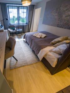 a bedroom with a large bed with a desk and a chair at Like Home 1 Perfect Classic Duo in Świdnica