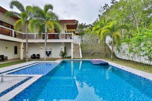 a swimming pool in front of a house at Cliff Haven Villa Krabi in Ao Nang Beach
