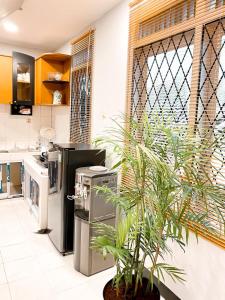 a kitchen with a potted plant in a room at Villa Sindang Restu Sr 19 Private Pool 4Br 15 Pax in Cianjur