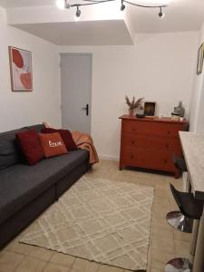 a living room with a couch and a dresser at La maison du bonheur in Caumont-sur-Durance