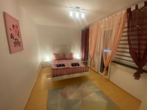 a small room with a bed and a window at Chic & Trendy Mainz Apartment near cetral station in Mainz