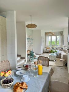 a living room with a table with food on it at Wishome-Casa con bonito jardín y piscina, ideal para familias, cerca de Comillas in Prellezo +15 photos