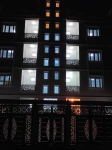 a tall building with lit windows at night at Résidence Le Figuier Marako, Tizi-Gheniff 